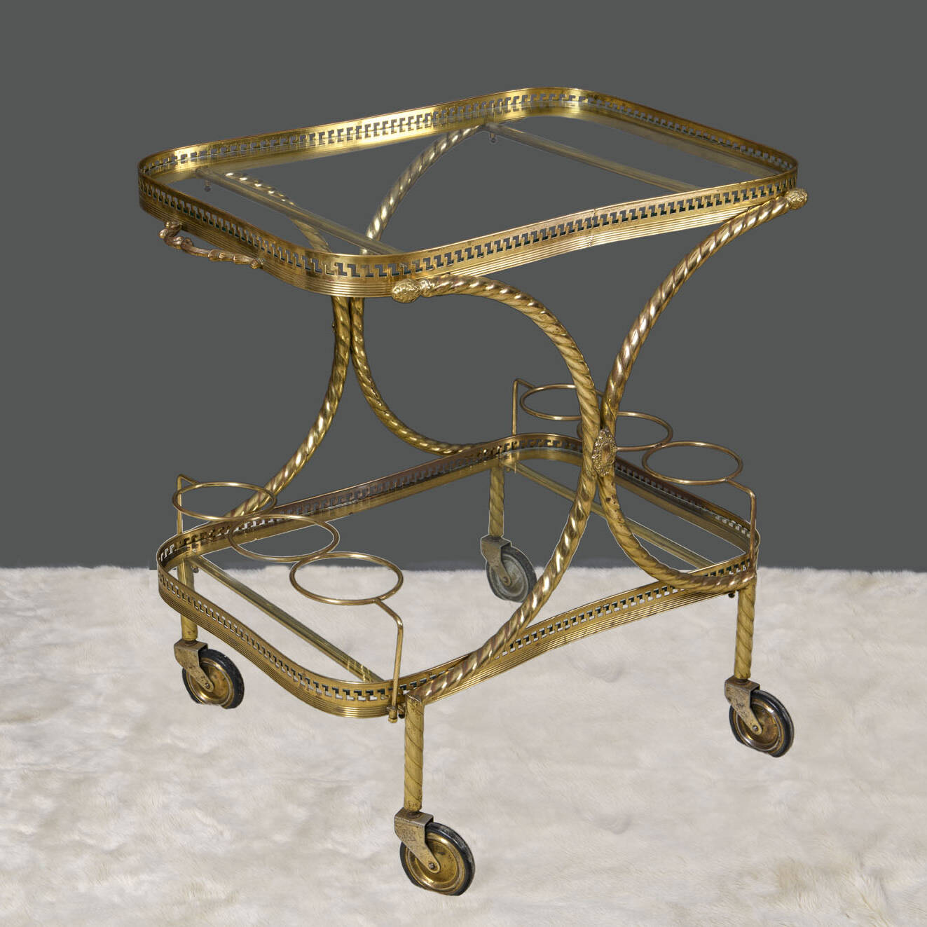 Carrello in ottone e vetro a due ripiani con bordure a greca e portabottiglie ad anelli